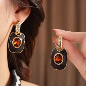 Vintage gold oval jewelry set with black enamel, orange gem and crystal accents