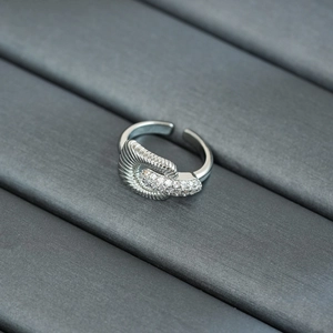 Macro shot of silver-plated twisted ribbon ring with sparkling zircon insets