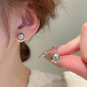 Detailed view of grey pearl earrings with curved pavé zircon setting on silver base