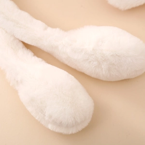 Close-up of soft white plush fabric detail on cute cartoon moving panda earmuffs