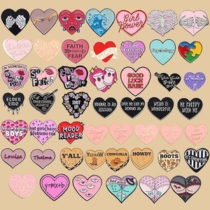 Variety set of heart-shaped metal enamel pins featuring unique creative graphic designs