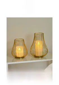 Modern gold metal hollow cage candle holders with warm LED pillar candles on shelf