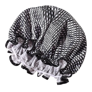 Close-up of black and white checkered shower cap with elastic band and piping