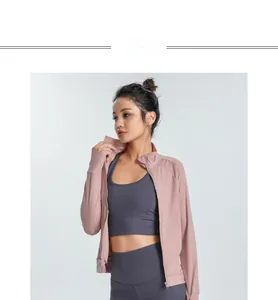 Detail of pink slim-fit zipper jacket and grey leggings for yoga and fitness training