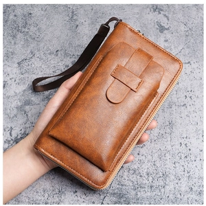 Brown leather long wallet with wrist strap and front buckle pocket shown in hand
