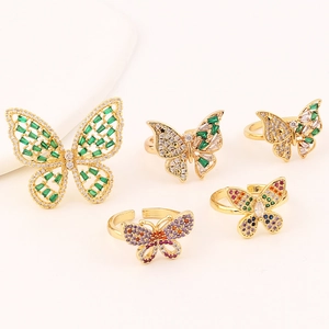 Macro shot of 5-piece gold butterfly rings set with colorful zircon and micro-inlays