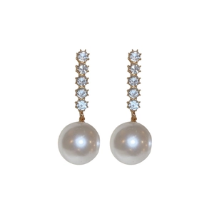 Elegant vertical gold earrings featuring crystals and a large round white pearl drop