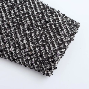 Macro detail of black and white sequined tweed fabric texture with sharp weaving details