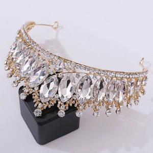 Macro detail of golden baroque crown with sparkling red crystals and inlaid rhinestones