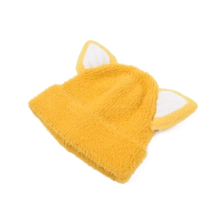 Detail of yellow fuzzy knit hat featuring cute animal ears and soft plush texture