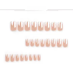 Detail showing various sizes of nude French manicure press-on nails with white tips