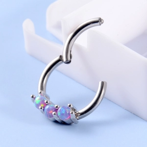 Detail view of silver steel hoop ring featuring three pink purple opal stones
