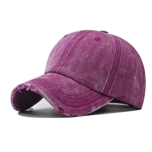 Detailed view of vintage washed purple denim baseball cap with distressed frayed brim