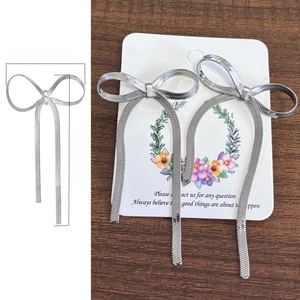 Silver bow long tassel earrings showing dimensions of 3.5cm width and 6.5cm height