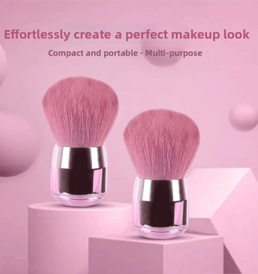 Detail of pink kabuki makeup brush on a pedestal for loose powder and blush