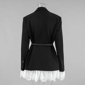 Detailed back view of black blazer featuring white eyelash lace hem and slim leather belt