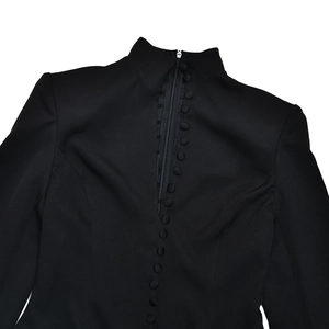Detail of black blazer dress back featuring invisible zipper and decorative buttons