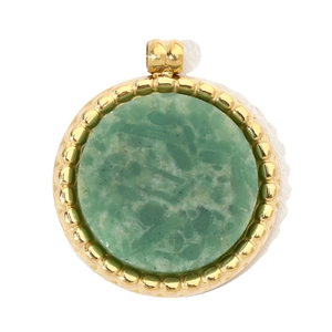 Detail of round gold pendant with natural green stone inlay and beaded metal edges