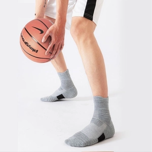 Detail of gray athletic crew socks featuring arch compression and breathable mesh design