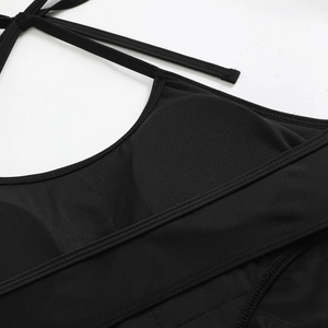 Detailed macro view of honeycomb texture fabric and stitching on black halter swimsuit