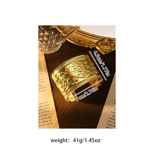 Makroaufnahme des goldenen Bohemian-Armreifs mit filigranen barocken Blumenschnitzereien