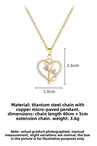 Detailed view of gold heart necklace with pink gemstones and cubic zirconia pendants