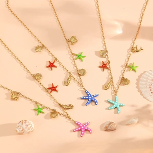 Golden titanium steel ocean theme necklace with enamel starfish and sea life charms