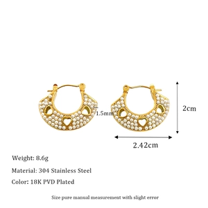 Detailed view of hollow heart pearl earrings in 18K gold-plated stainless steel