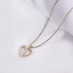 Elegant gold heart pendant necklace with pearls and rhinestones on a box chain