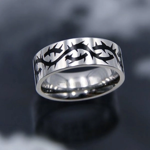 Titanium steel punk rock ring featuring black thorn patterns and a polished silver finish