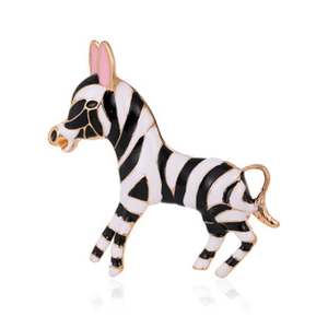 Detailed macro shot of a zebra brooch with black and white enamel and golden trim