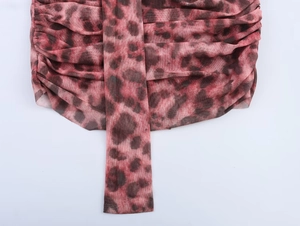 Detail of pink leopard print mesh fabric featuring pleated texture and tie-up design