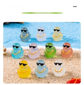 Micro landscape duckling figurines with sunglasses and gold chains on beach sand decoration