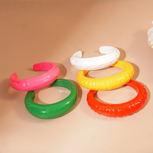 Bracciali aperti in acrilico colorato con design a pieghe in vivaci tonalità caramella
