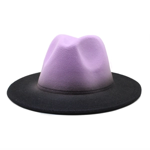 Detail of the gradient purple to black felt fedora hat with a wide brim on white background
