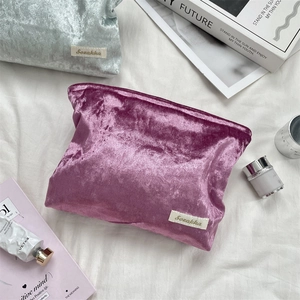 Detail of soft velvet makeup bags in purple and blue with smooth zippers for travel