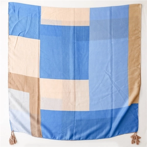 Close-up of geometric color block cotton linen scarf with tassel detail and soft texture