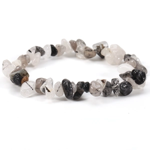 Elastic bracelet with irregular black and white natural stone chips on a white background