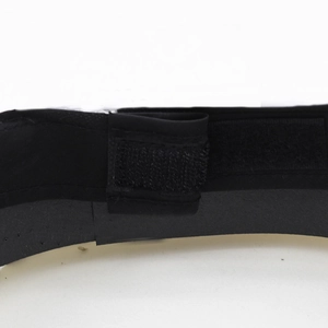 Detail of black military style hat showing velcro strap and textured synthetic fabric