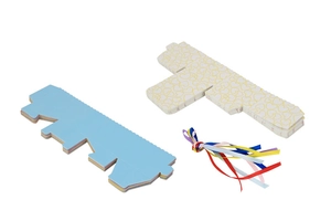 Materials for DIY candy boxes including blue cardstock, heart patterns, and colorful ribbons