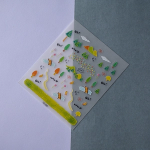 Detailed macro view of 5D green forest nail art stickers with embossed trees and mountains