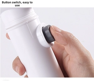 Detail of ergonomic handle and power button on portable electric cleaning brush