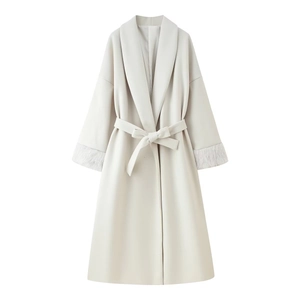 Close-up of elegant long wool coat with tie waist belt and plush faux fur cuffs