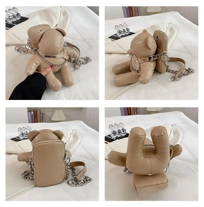 Detail view of khaki bear PU leather crossbody bag with metal chain and rivet straps