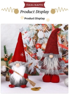 Detail of Christmas gnomes with red felt hats, gray fur bodies and snowflake embroidery