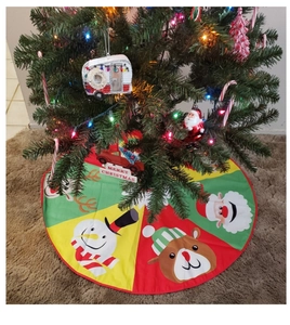 Detailed view of festive Christmas tree skirt with cartoon Santa and reindeer patterns