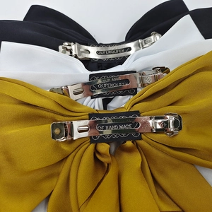 Large vintage satin bow hair clips in black, white and yellow with metal spring clips