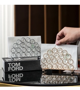 Detail view of a luxury gold crystal tissue holder with faceted glass beads and napkin
