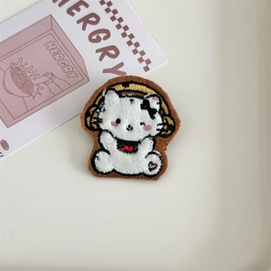 Detailed embroidery of white cartoon cat wearing headphones on a soft plush brooch patch