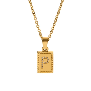 Macro detail of gold rectangular pendant with crystal-encrusted letter P on metal chain